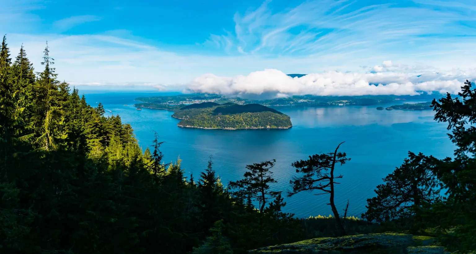 Summit Views from Mount Gardner on Bowen Island looking over the Salish Sea and other islands and mountain ranges.